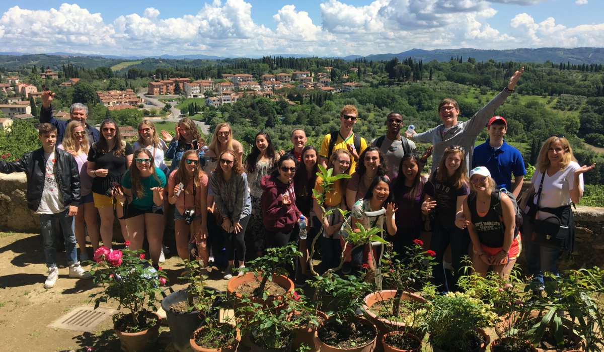 Catholic University students on terrace overlooking Italian countryside